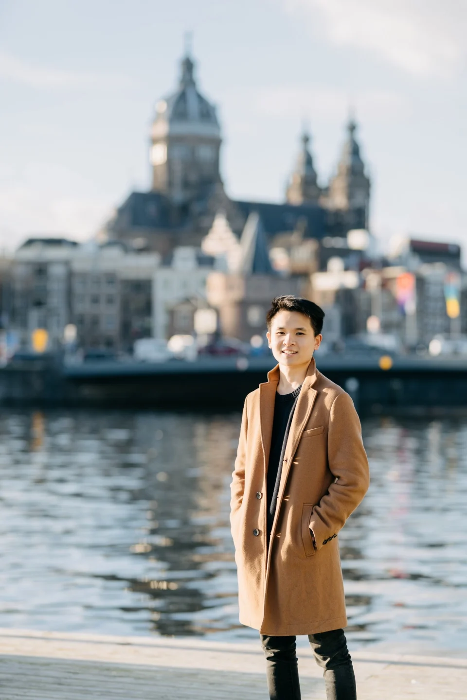 Fernando Abednego Halim standing beside the water in Amsterdam